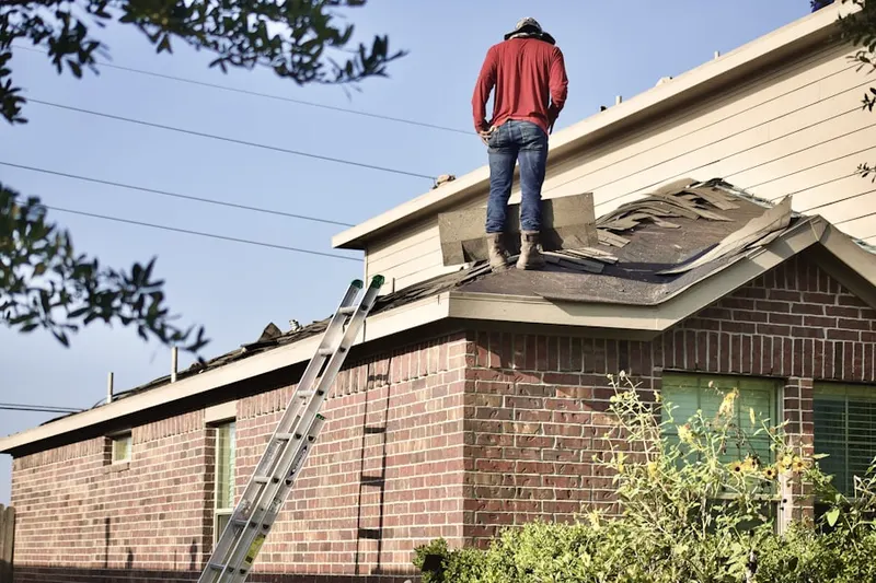 Professional roofer working on a residential roof in Jupiter Village
